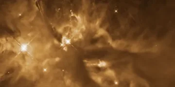 Protoestrela brilhante à esquerda está localizada dentro das Nuvens Moleculares de Órion • NASA, ESA e T. Megeath (Universidade de Toledo)