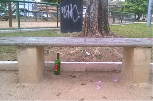 THADEU SANTOS Garrafa de bebida alcoólica, banco, painel e postes pichados