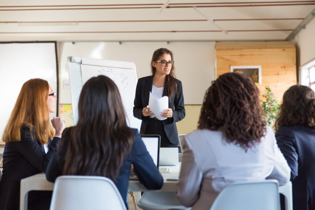 businesswomen looking speaker with papers