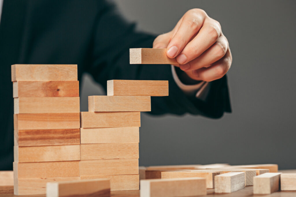 man wooden cubes table management concept