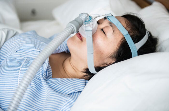 woman wearing anti snoring chin straps