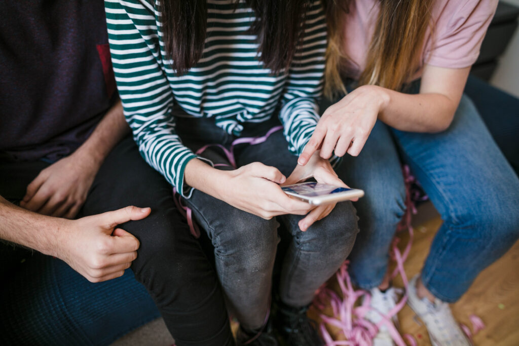 high angle group friends checking phone