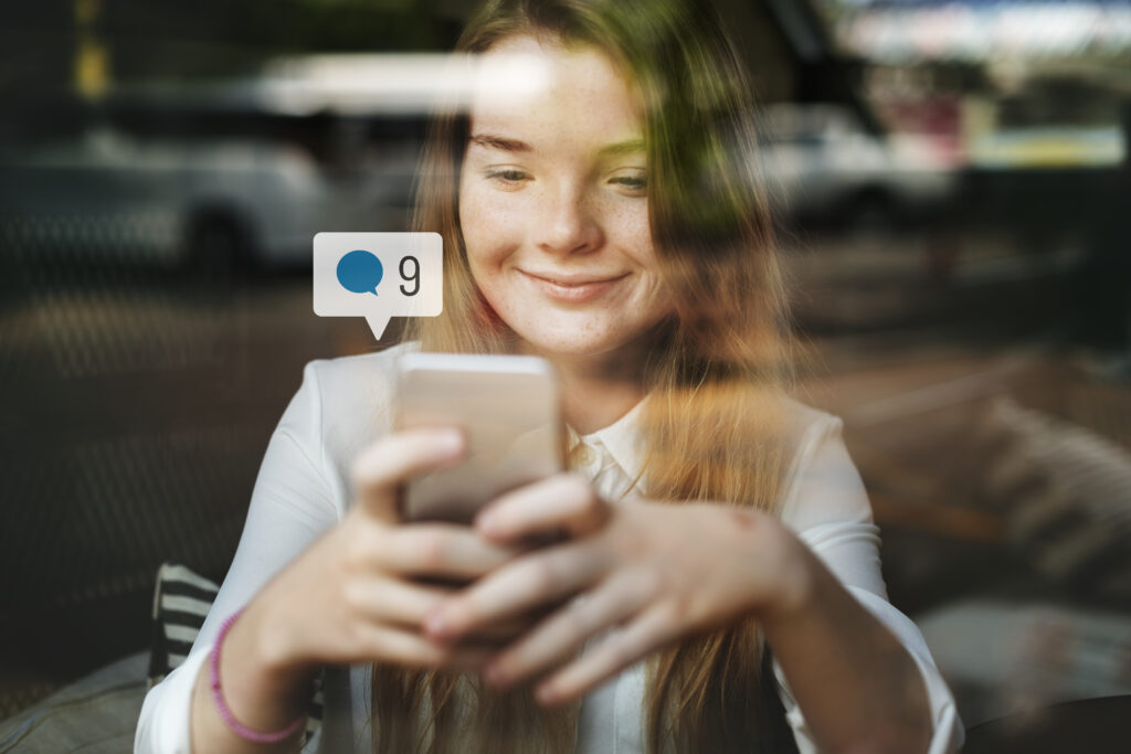 happy girl using social media smartphone cafe